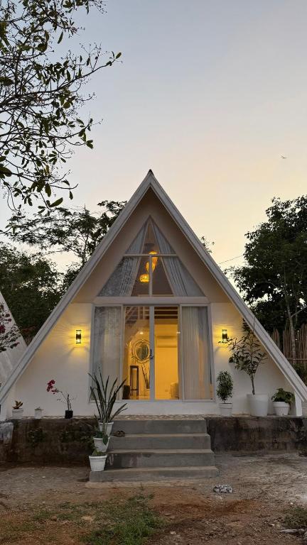 a small white house with a window and stairs at Cabin Mattias in Coron
