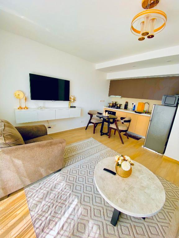 a living room with a couch and a table at Nairobi Comfort Suites in Nairobi