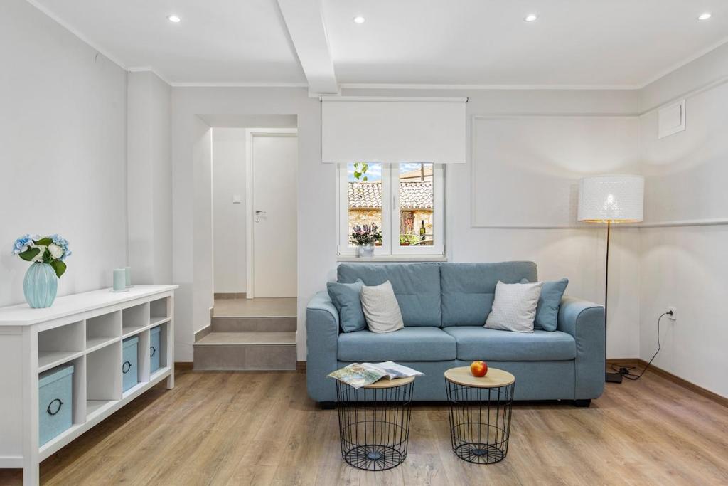 a living room with a blue couch and a table at Apartment Katja in Vantačići