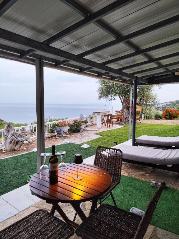 a table with a bottle of wine on a patio at Off Grid Romance in Samos in Ireon