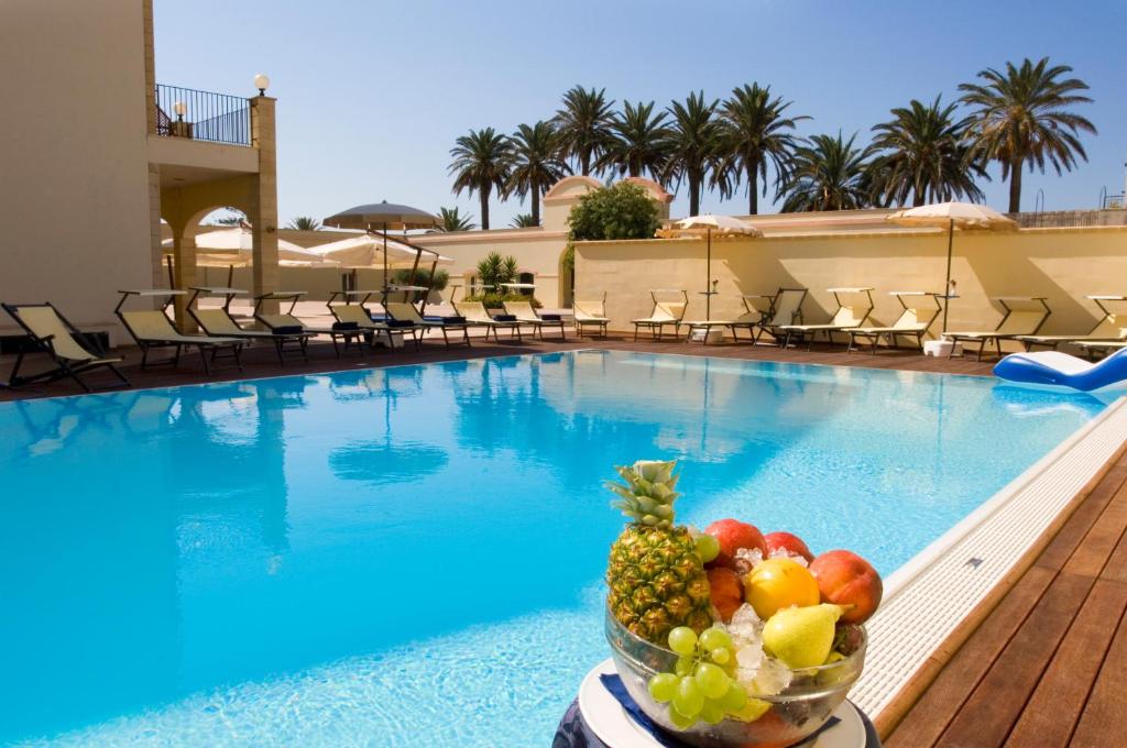 a bowl of fruit sitting on top of a patio at Mahara Hotel & Wellness in Mazara del Vallo