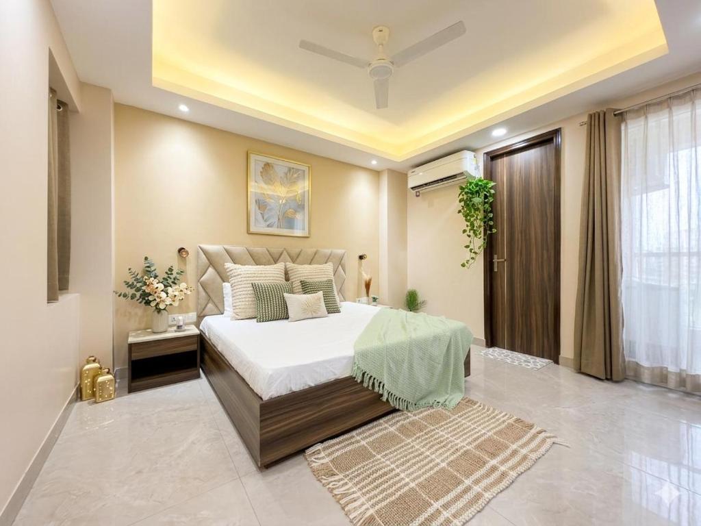 a bedroom with a large bed and a window at The verdant corner in Gurgaon