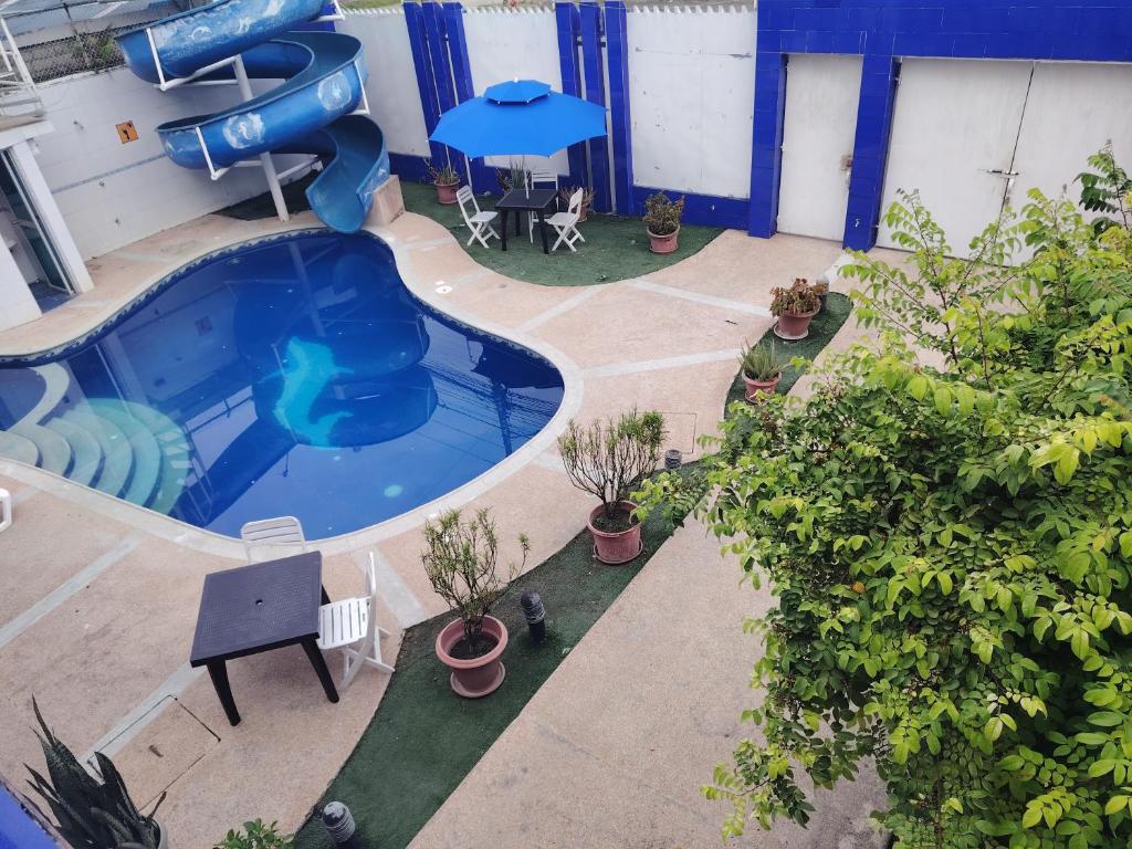 an overhead view of a swimming pool with a slide at Casa suites golden in Tonsupa