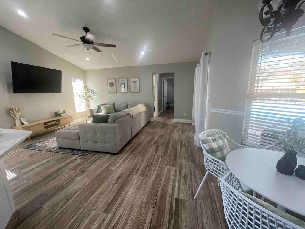a living room with a couch and a table at Spacious Home w heated Pool SmartTVs Pool Table in Riverview