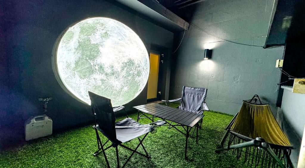 a room with two chairs and a round window at Mc9Hotel in Uijeongbu