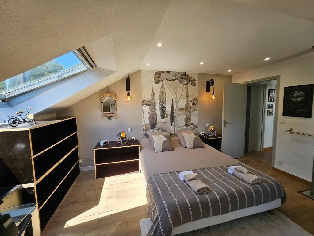 a bedroom with a large bed and a window at chambres de La Maillette in Locminé
