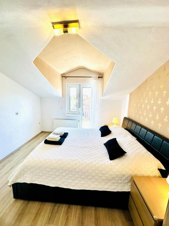 a bedroom with a large bed with a ceiling at Maja - Apartment 1 in Funtana