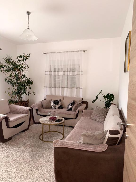 a living room with two couches and a table at Apartment Guberinic in Tivat