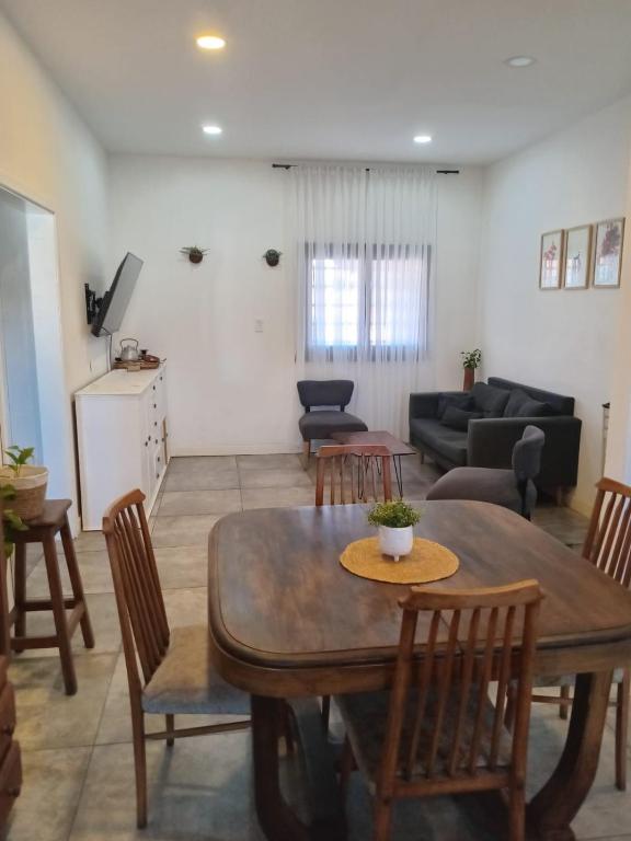 a living room with a table and chairs at Dambofamily in Necochea