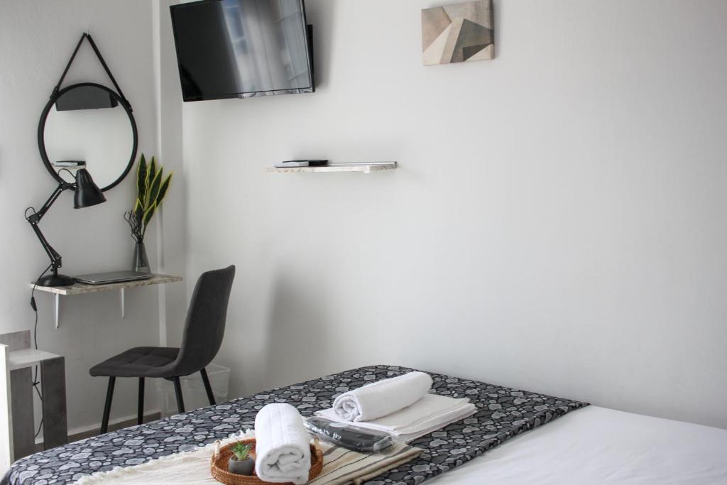 a table with a tray of towels and a mirror at Scalo del Mare Apartment in Keramoti