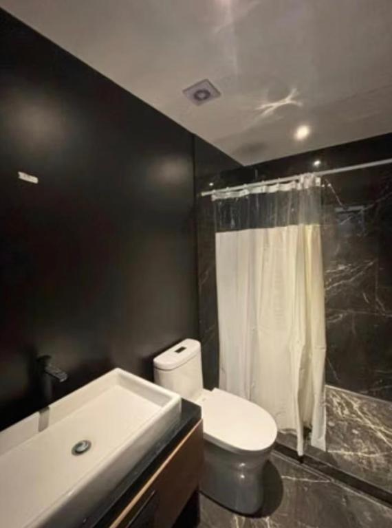 a bathroom with a white toilet and a sink at Saray-ı Hümayun in Santa Rosita