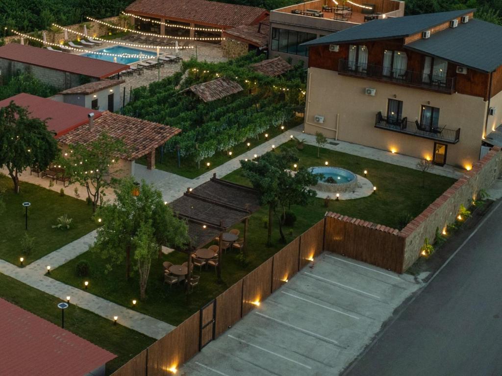an aerial view of a house with a garden and a swimming pool at Vineyard Hotel & Winery in Napareuli