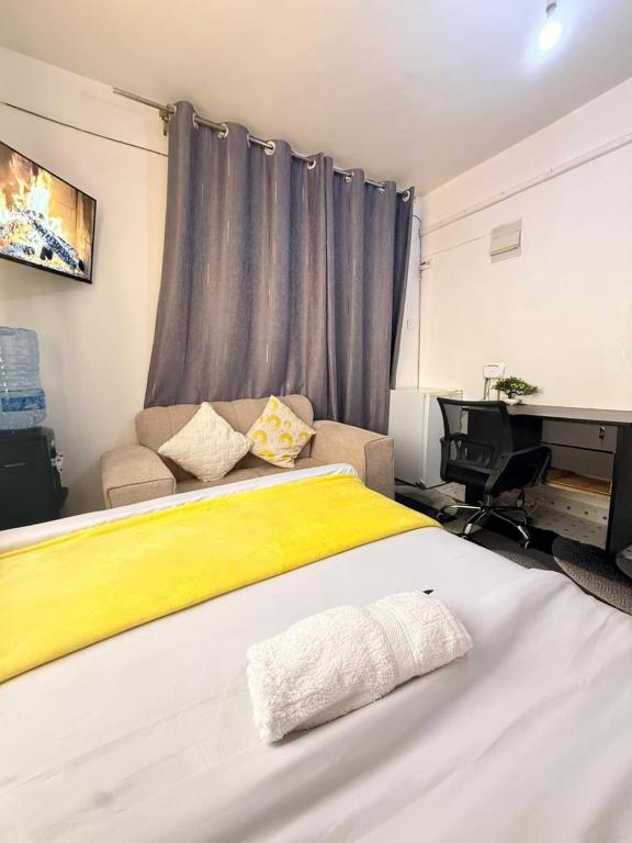 a bedroom with a large bed and a piano at Ruiru Cozy stays in Ruiru