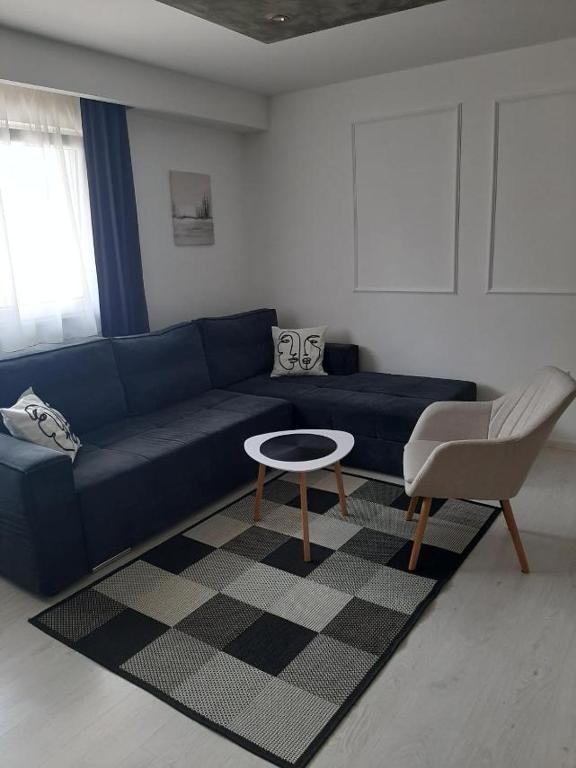 a living room with a blue couch and a table at Apartman Tijana in Pale