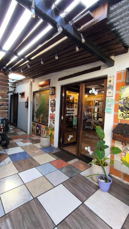 a lobby of a store with a checkered floor at Hostel y Motoposada Sudaka in Garupá