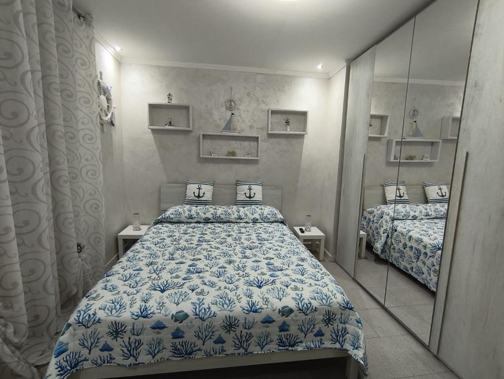 a bedroom with two beds and a mirror at Il BORGO in Lapedona