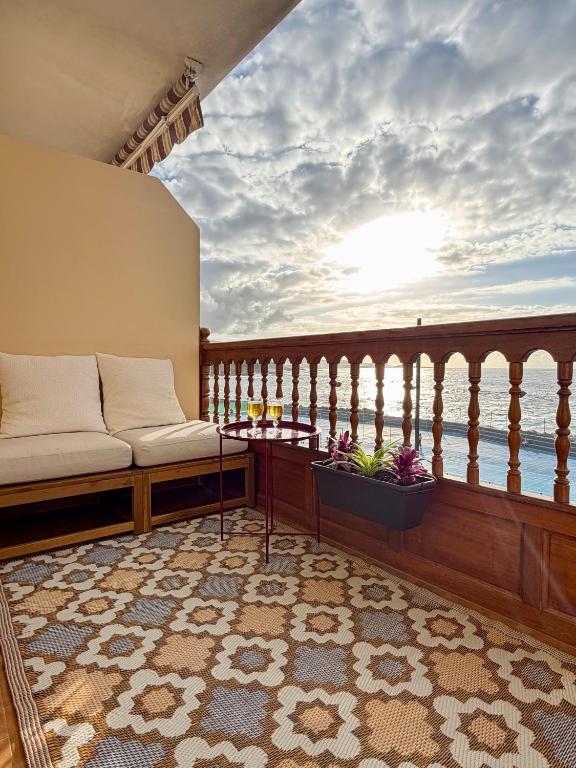 a balcony with a couch and a table and the ocean at Fajana de Trevejo in Garachico