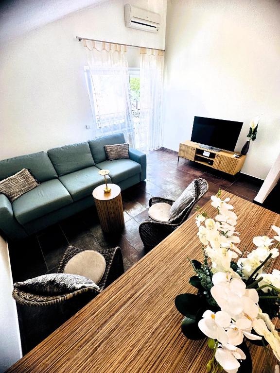 a living room with a blue couch and a table at Maja Apartment 3 in Funtana