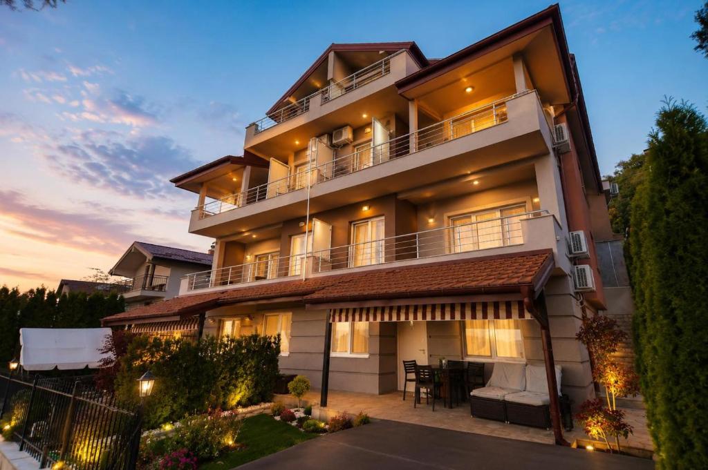 aominium building with a sunset in the background at Velestovo House in Ohrid