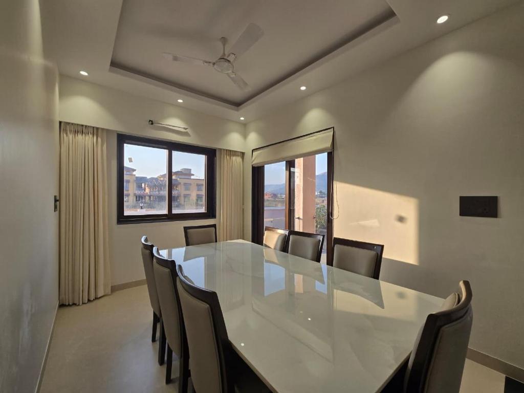 a dining room with a white table and chairs at Kamal in Kārli