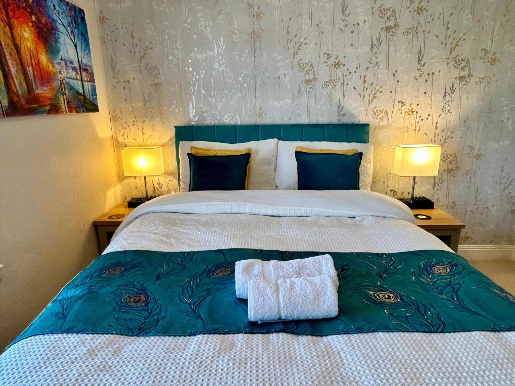 a bedroom with a bed with two towels on it at Character Bedford Apartment with Two Bedrooms in Bedford