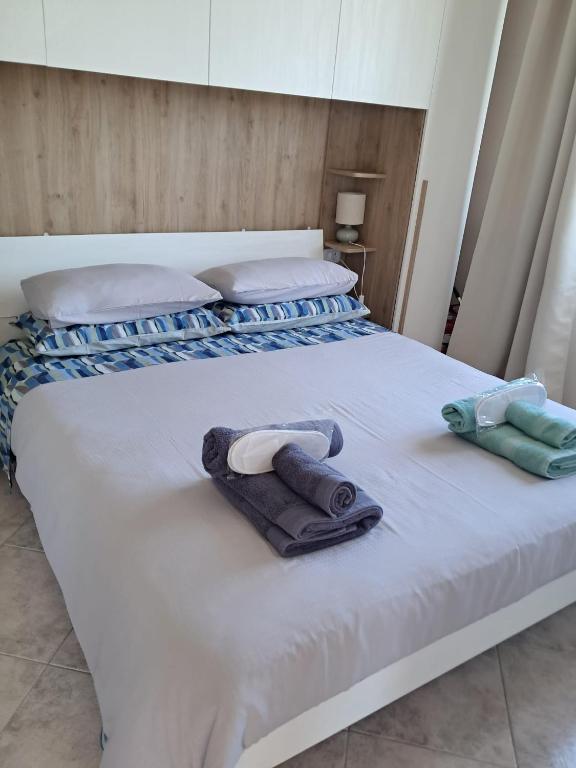 a bed with two pillows and a towel on it at Bella Todi Apartment in Todi