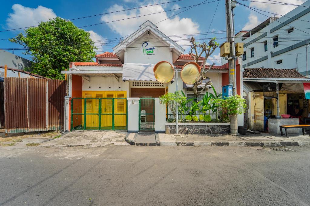 a house with colorful doors on a street at Roemah Noni Baciro By ARBA in Demangan