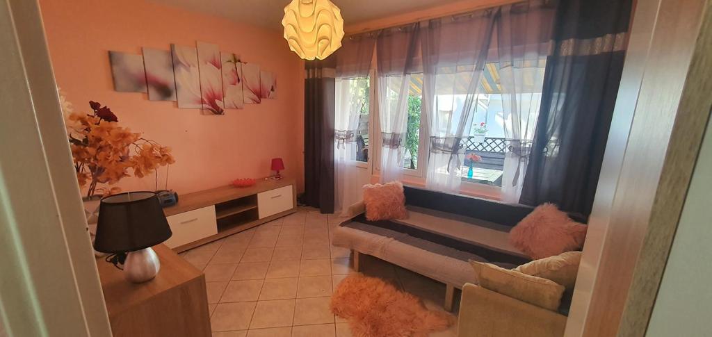 a living room with a couch and a window at POD SOSNAMI - ul Dominicka 28 in Boszkowo