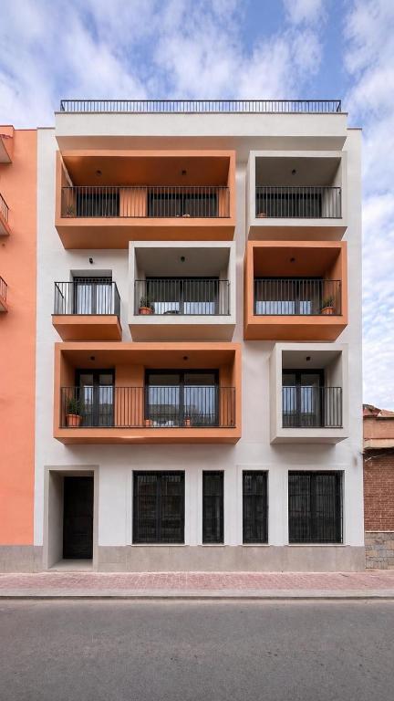 an apartment building with balconies on the side of it at OMO STAYS Pinada Park in Guardamar del Segura