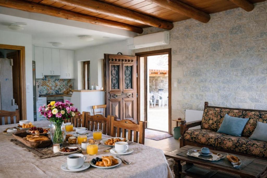 a living room with a table with food on it at Villa Amalthia Panorama in Bozikás