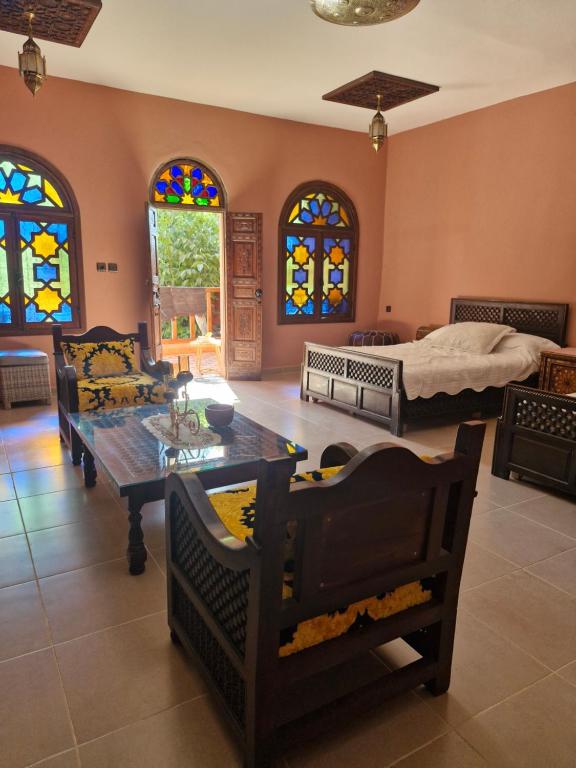 a living room with a bed and a table and chairs at Casa Sofia in Meknès