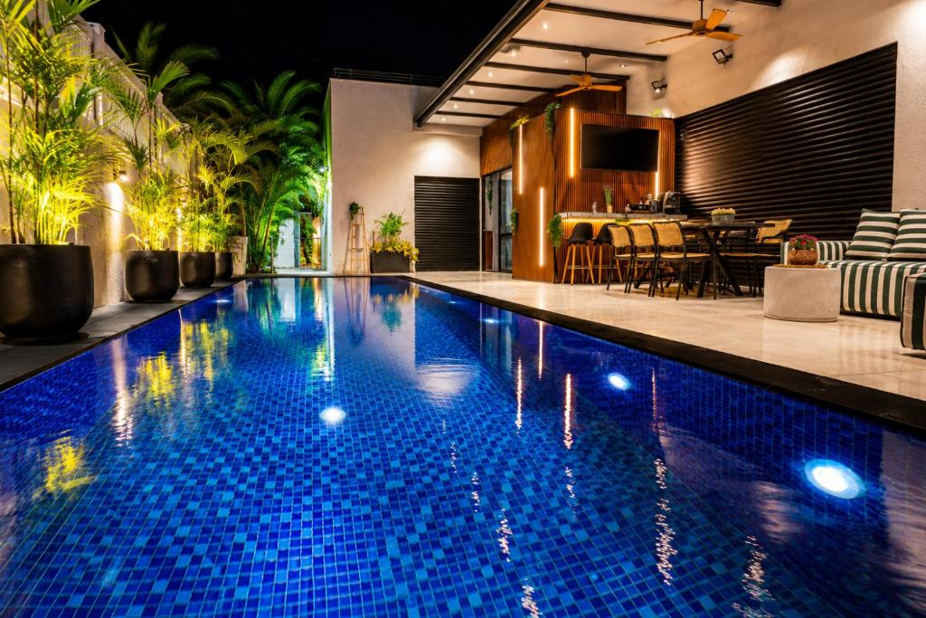 a swimming pool with blue tiles in a house at Royal Water Villa in Kiryat Ekron