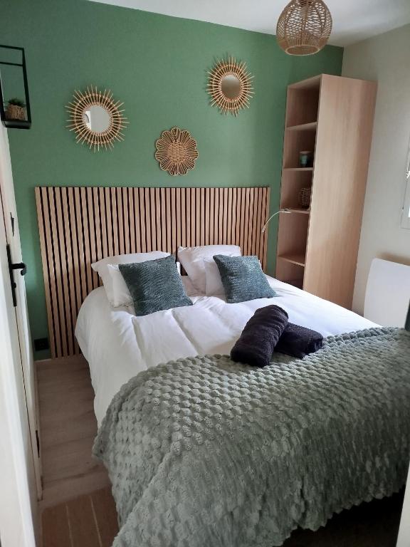 a bedroom with two beds and two mirrors on the wall at Le reflet de Cabourg avec accès direct plage in Cabourg