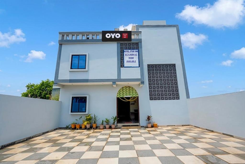 a white building with aoc sign on it at HOTEL O STAR INN in Raipur