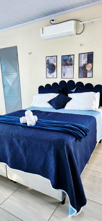 a bedroom with a blue bed with a stuffed animal on it at Mini Apartamentos na entrada de Tutóia in Tutóia