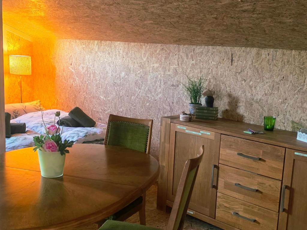 a dining room with a table and a bed at Cozy Cow Farm Lodge in Lucerne