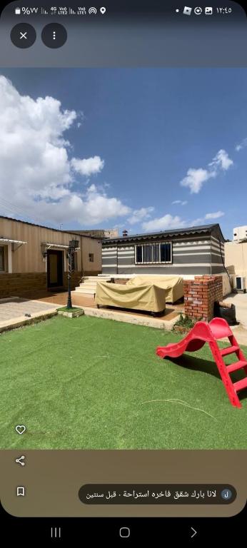 a view of a yard with a red object on the grass at بيت لانا in Abha