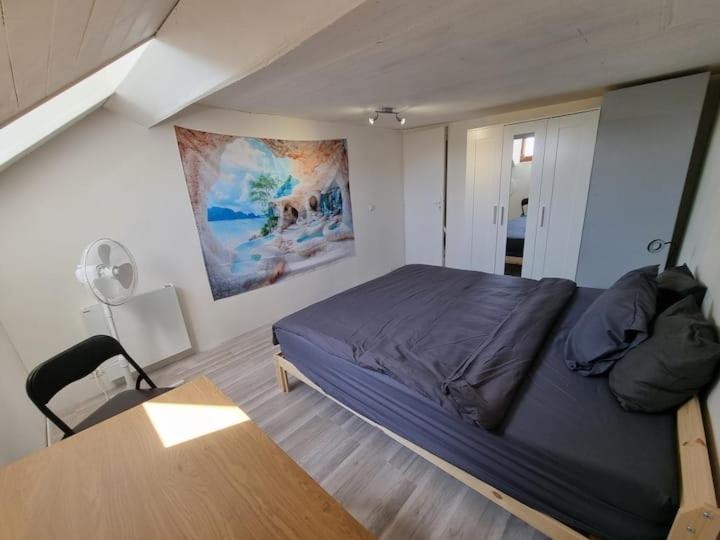 a bedroom with a bed and a desk in it at Geneva House G in Ferney-Voltaire