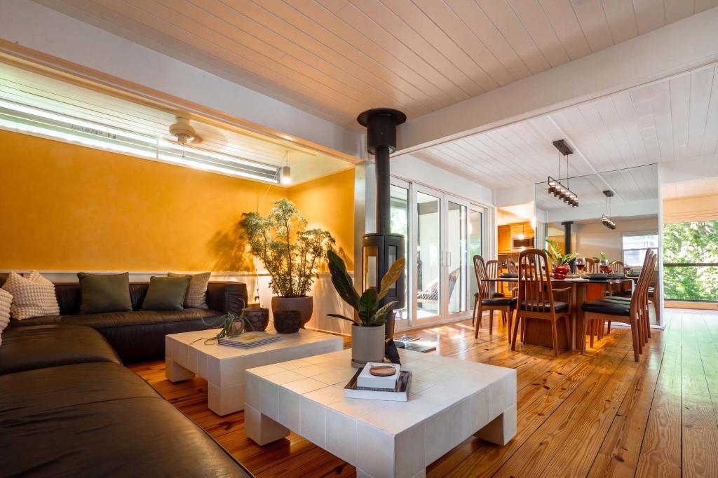 a living room with a couch and a table at TreeTops Spacious Architectural Retreat in Gainesville