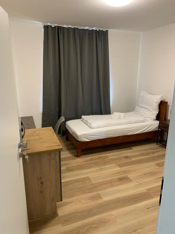 a small room with a bed and a window at Apartments Adelheid in Wathlingen