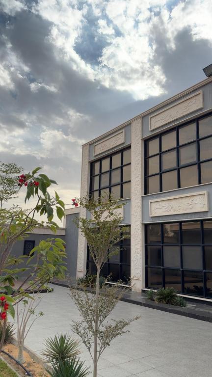 a building with a tree in front of it at Over lock in Buraydah
