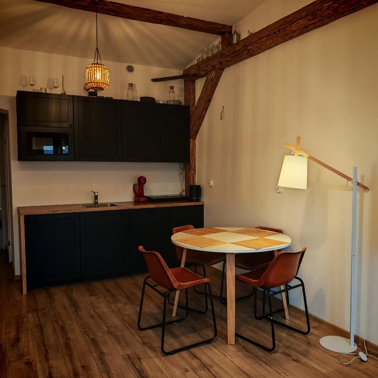 a kitchen with a table and chairs in a room at Bramkowa 5 in Skorka