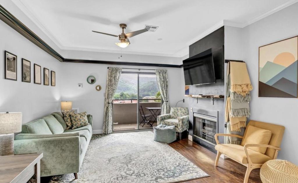 a living room with a couch and a fireplace at Uptown Gatlinburg in Gatlinburg