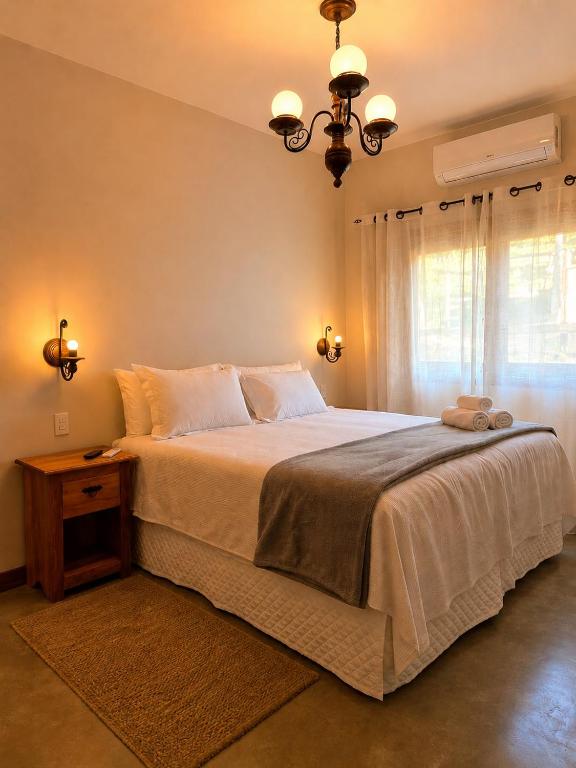 a bedroom with a large bed and a window at Pouso Alvorada in Tiradentes
