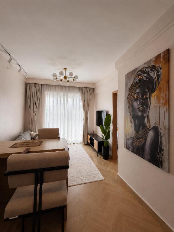 a bedroom with a black woman painting on the wall at Oderm one bedroom apartment in Syokimau near jkia airport and sgr station in Nairobi in Nairobi