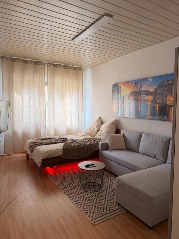 a living room with a couch and a table at Amor Mosel Stay in Klotten