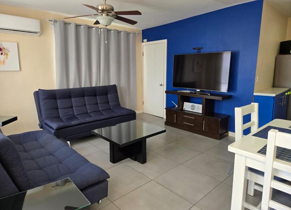 a living room with a couch and a tv at Independent apartment in San Antonio