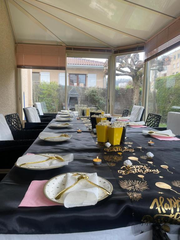 a long table with plates and glasses on it at DYNAMIQUE ET SPLENDIDE in Bourgoin