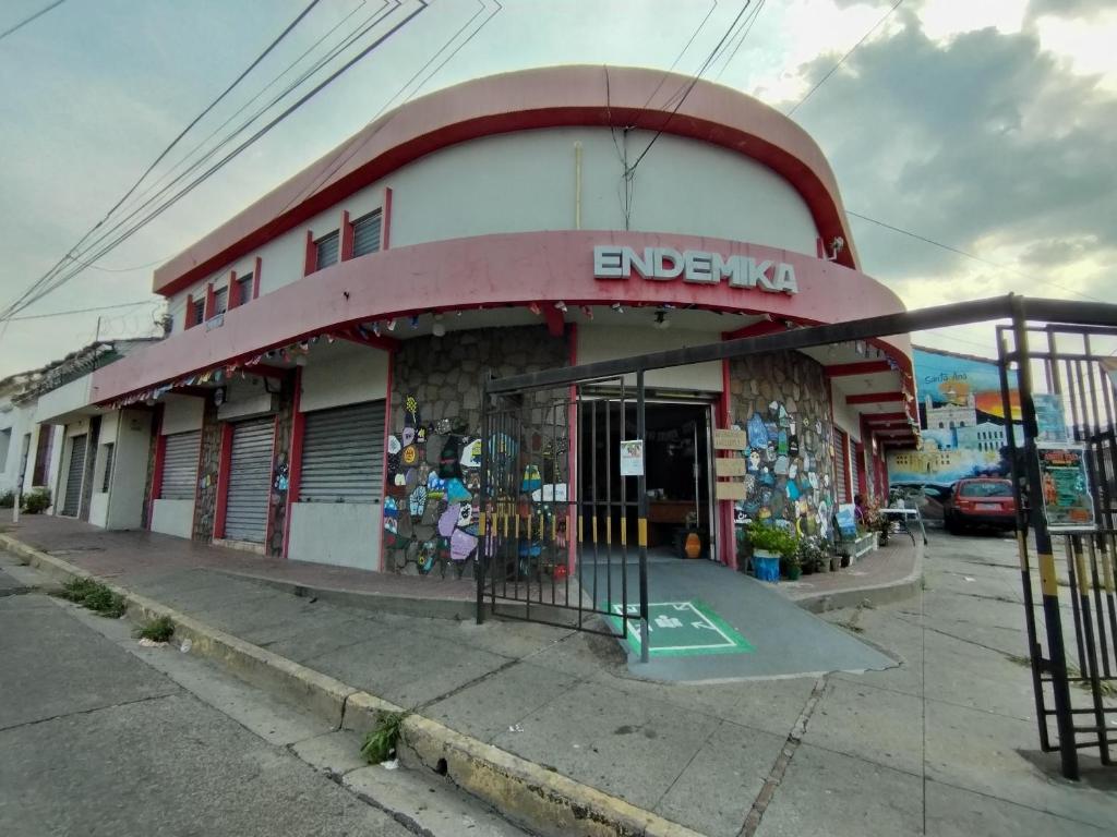 a building with a sign on the front of it at Yek Hostels in Santa Ana