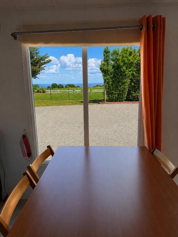 a table and two chairs in front of a window at Horizon Marin Escapade bord de mer à Cancale in Cancale